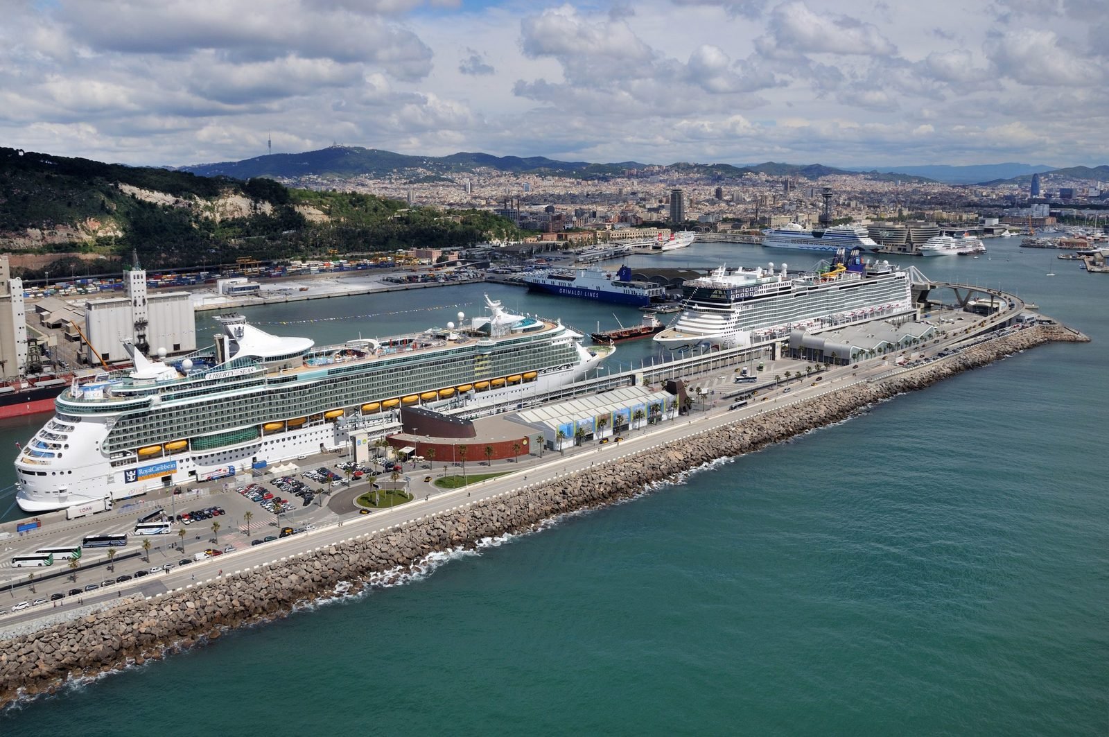 Cruise ships docked at the Port of Barcelona with the city behind