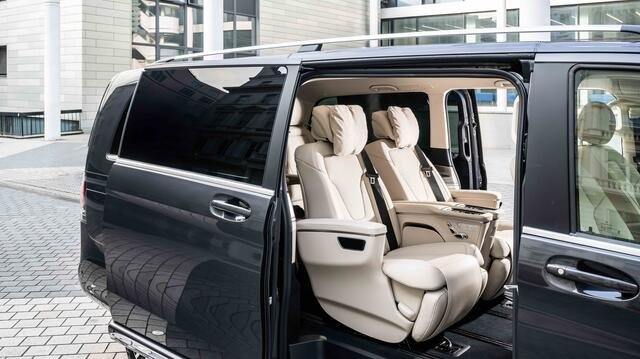 Premium van with sliding door open showing cream leather captain seats